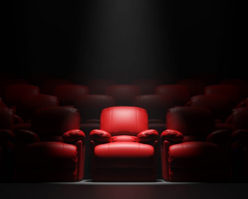 Red sofa Seat in front of black wall with spotight